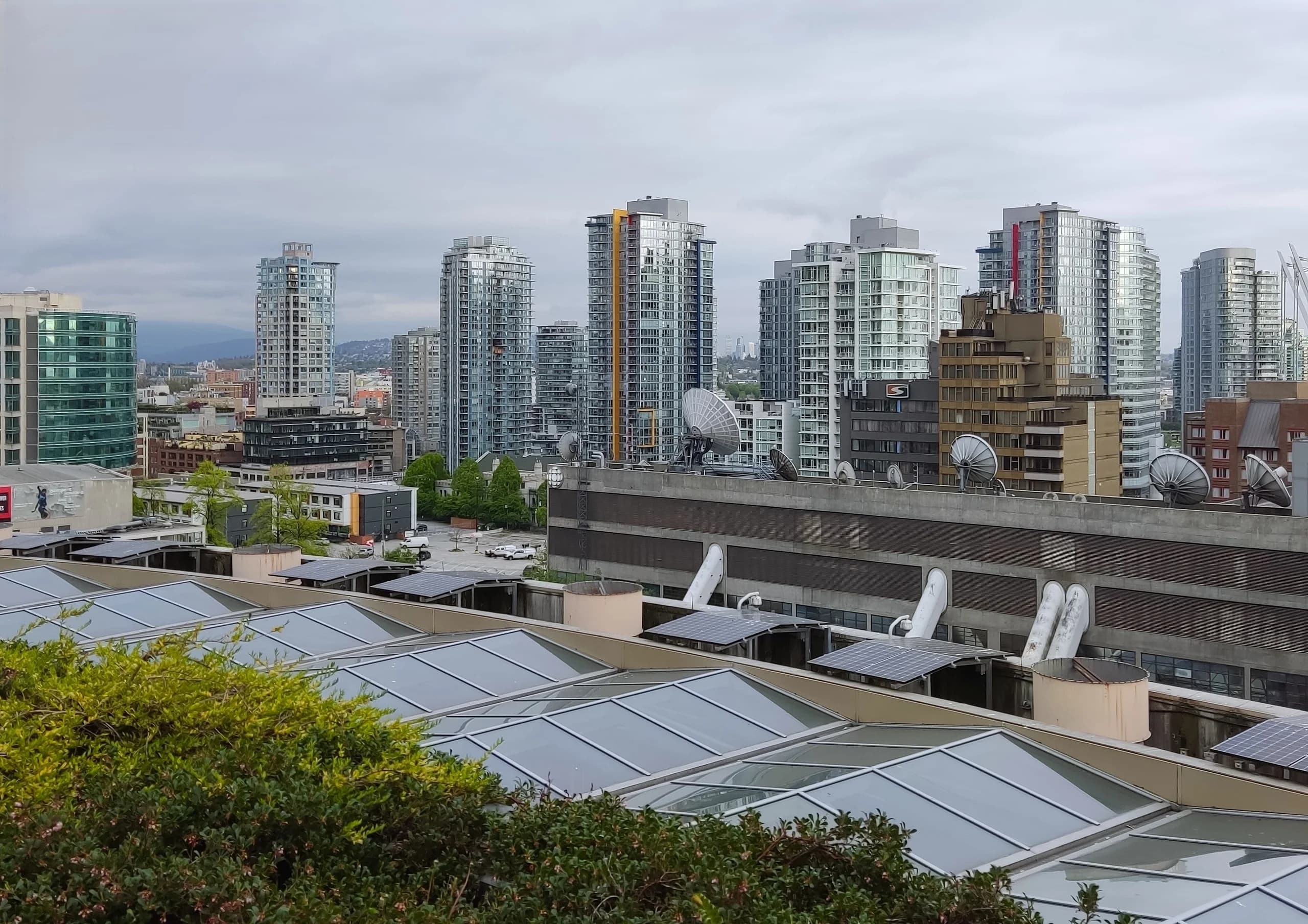 Urban skyline with modern high-rise condos in Canada under overcast skies.