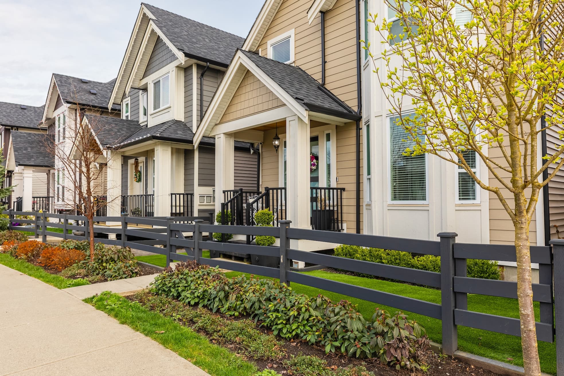Modern suburban homes with maintained lawns and energy-efficient designs.