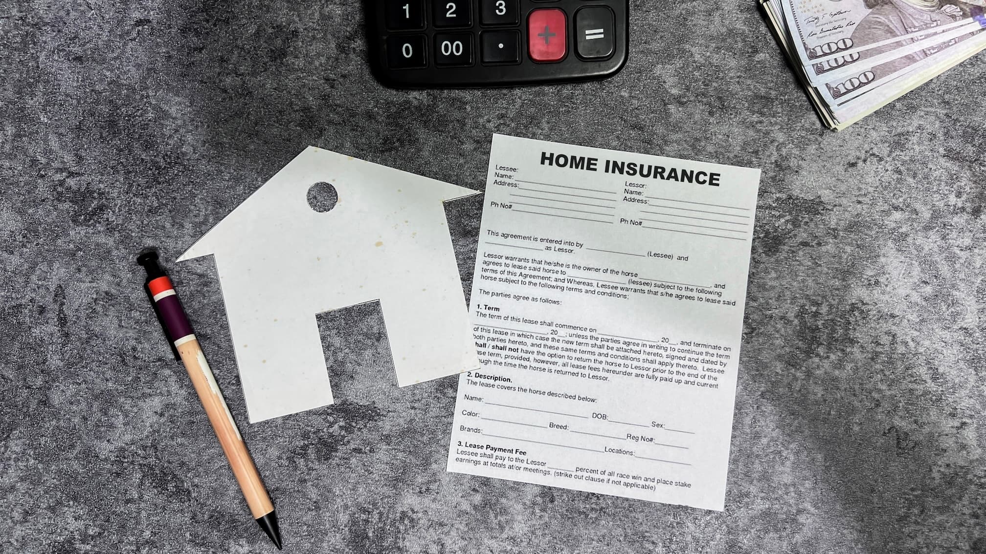 Home insurance document with paper house, pencil, money, and calculator on gray surface.