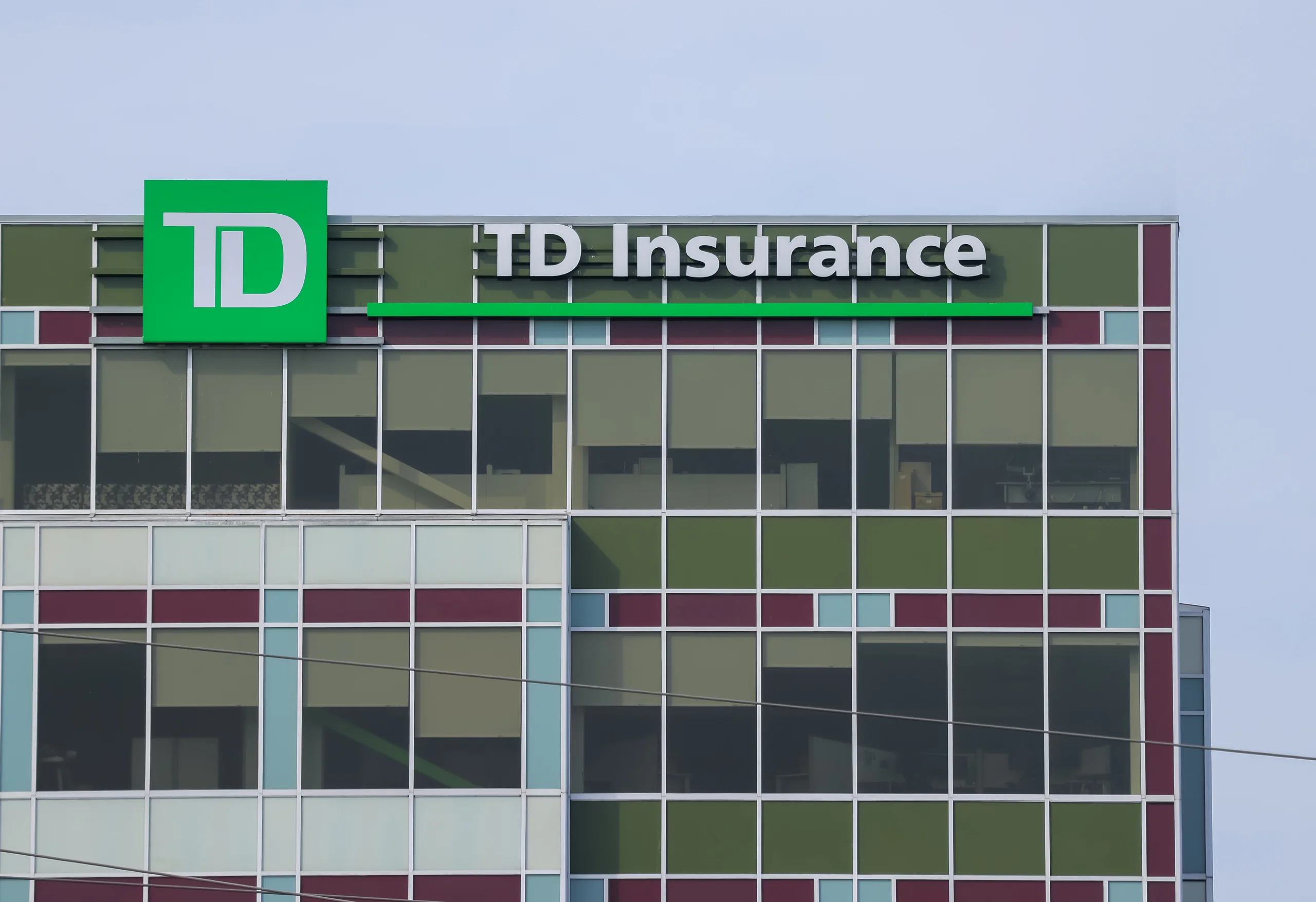 Facade of TD Insurance building with colored panels and glass windows.